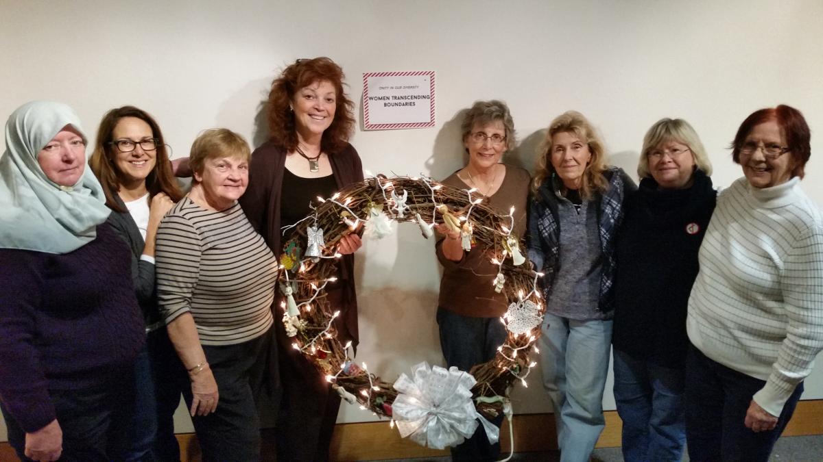 Donating a Christmas wreath with interfaith symbols to the Everson Festival of Trees