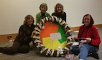 Donating a Christmas wreath with interfaith symbols to the Everson Festival of Trees